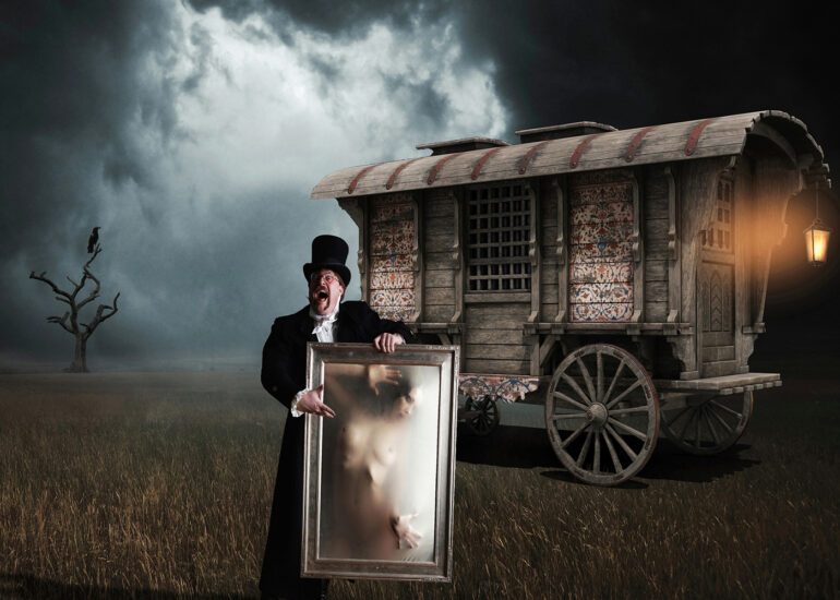 Surreal dark fantasy artwork depicting a Victorian showman holding a framed ethereal nude figure before a mysterious caravan under stormy skies, evoking gothic horror, illusion, and theatrical spectacle.