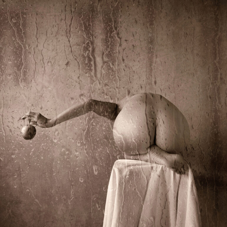 Contemporary fine art nude photograph with water, glass textures, and a calm, poetic atmosphere