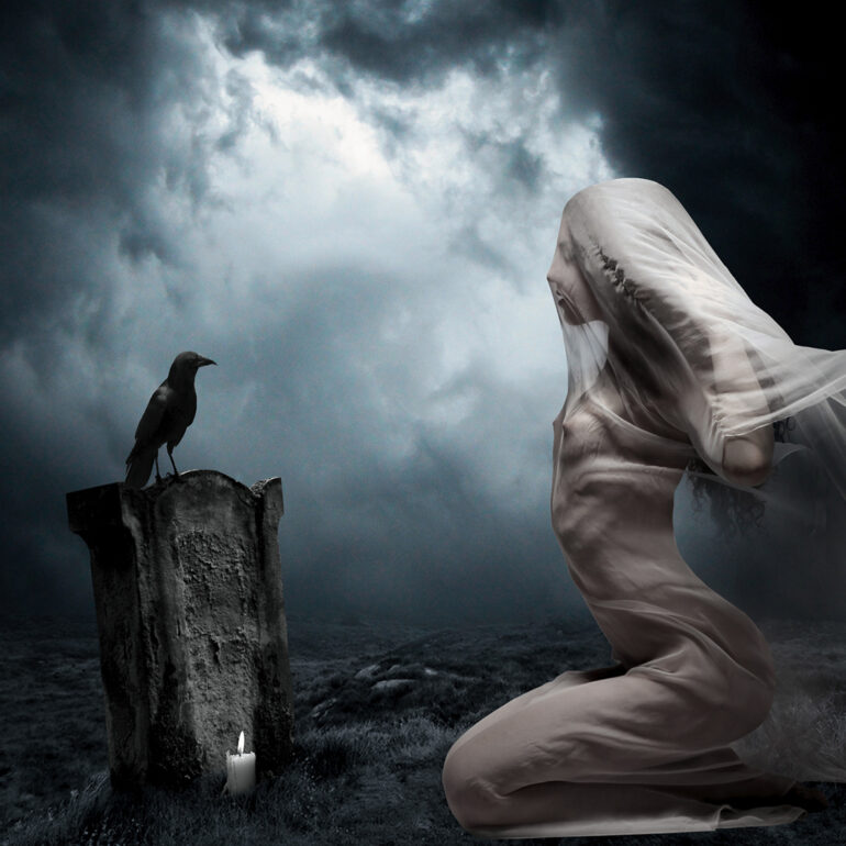 Surreal fine art artwork of a veiled nude woman kneeling before a grave with a raven perched upon it and candle in a mist-filled night landscape.