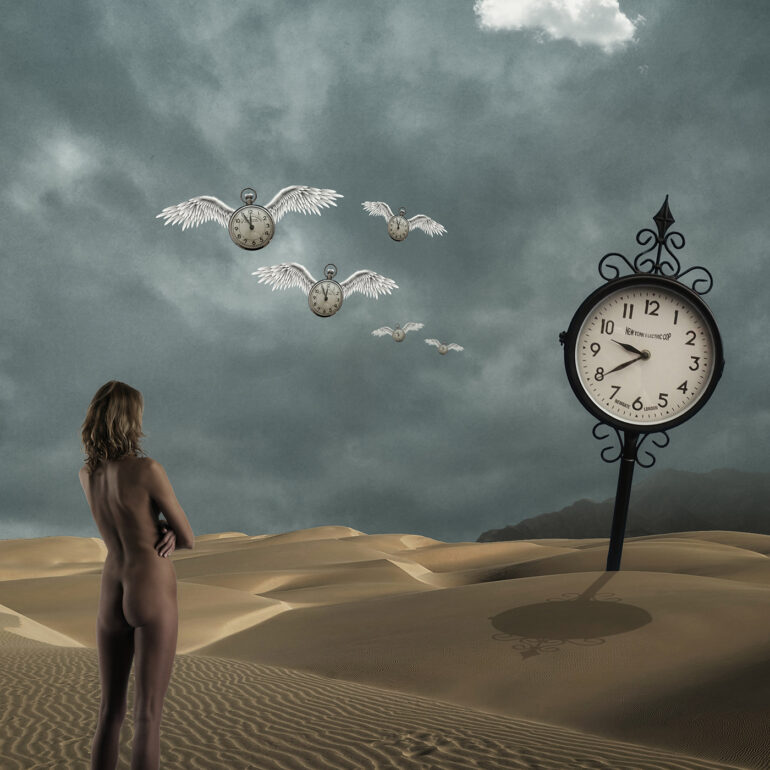 Surreal fine art nude artwork of a woman in a desert watching winged clocks fly across the sky, symbolising time and impermanence.
